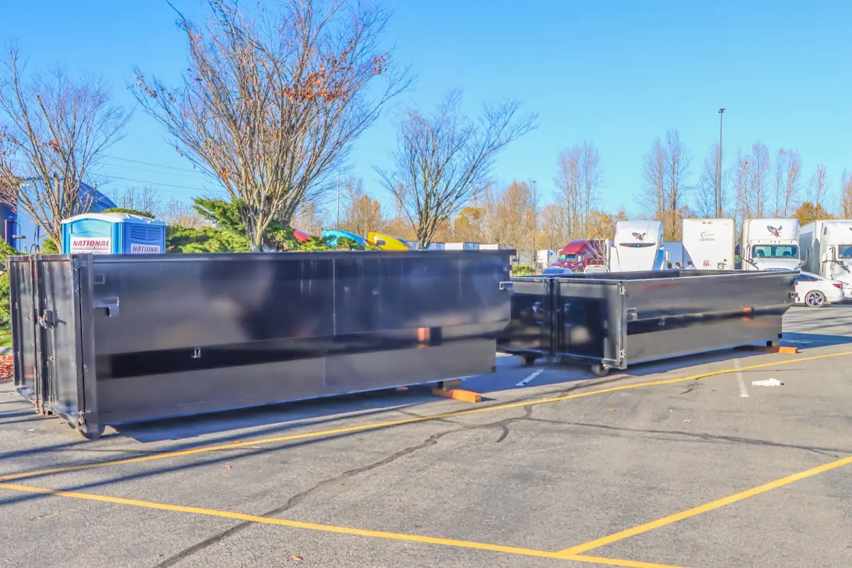 Professional dumpster rental service with roll-off container on residential driveway in Grayson